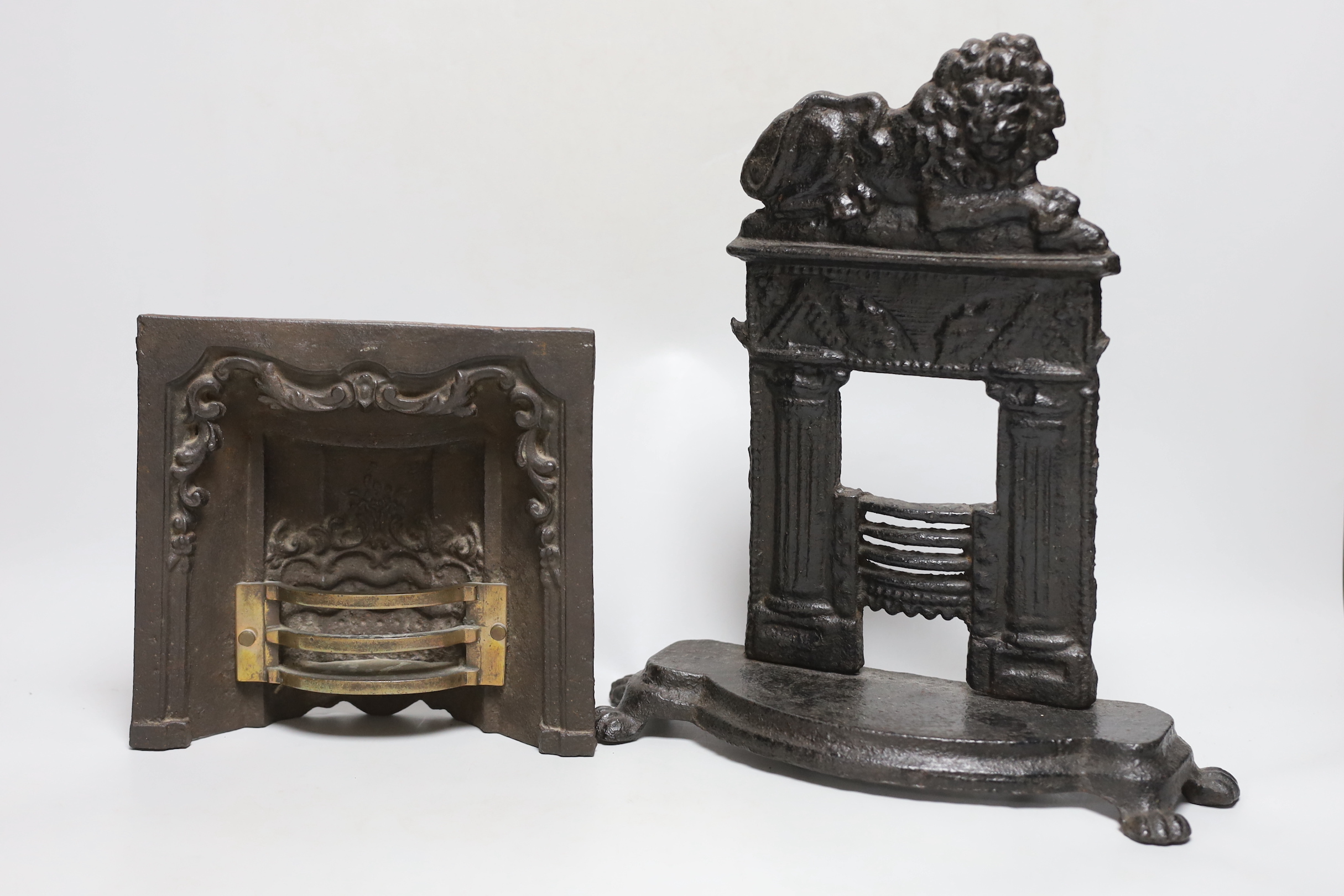 A Victorian cast iron model firegrate, a cast brass model firegrate and a similar stove, tallest 32cm